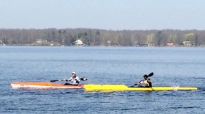 2 people paddling in kayaks.