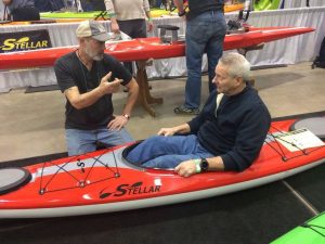 Joe Zellner talking with a customer in a Stellar Kayak.