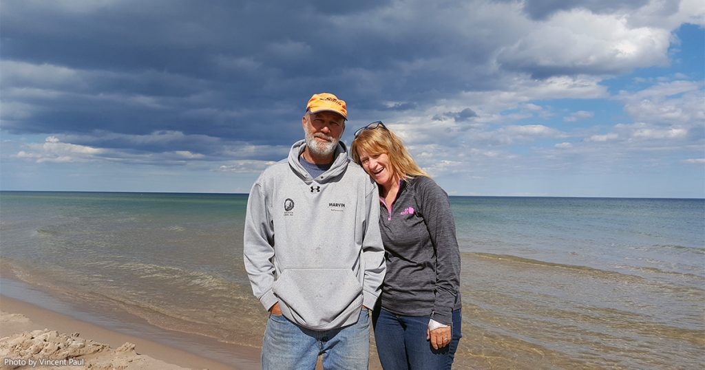 Joe and Peggy from 2 Paddling 5 on the beach of Lake Michigan at Kohler-Andrae State Park.
