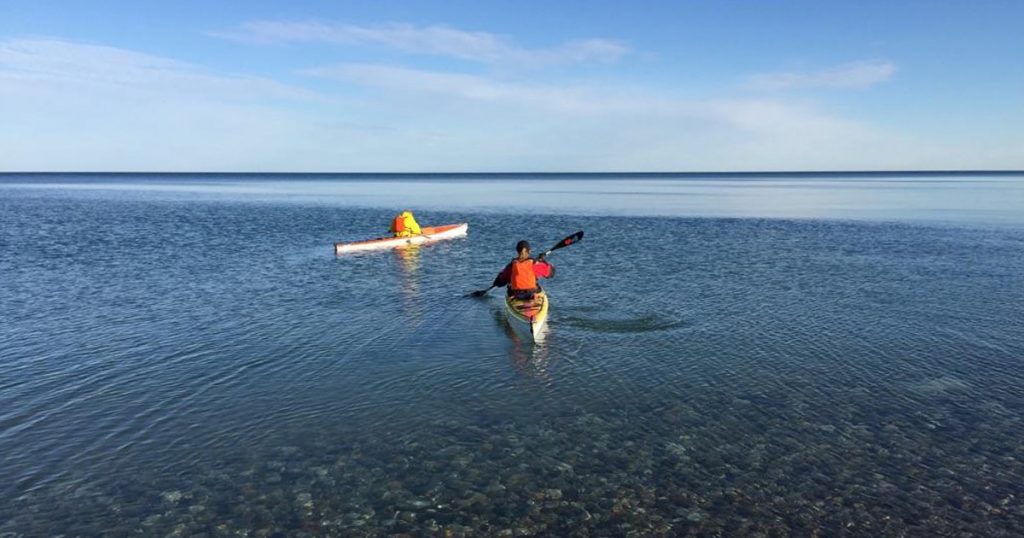 Kayaking out of Orchard Beach State Park Michigan on Lake Michigan.