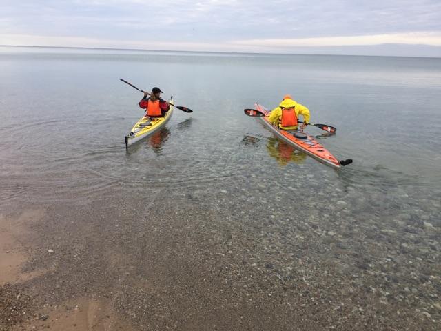 Paddling away on kayaks from Orchard Beach State Park Michigan.
