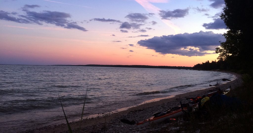 Rock Island State Park sunset with kayaks on shore.