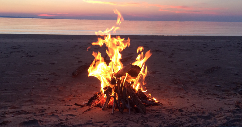 Lake Superior sunset with a campfire on the beach.