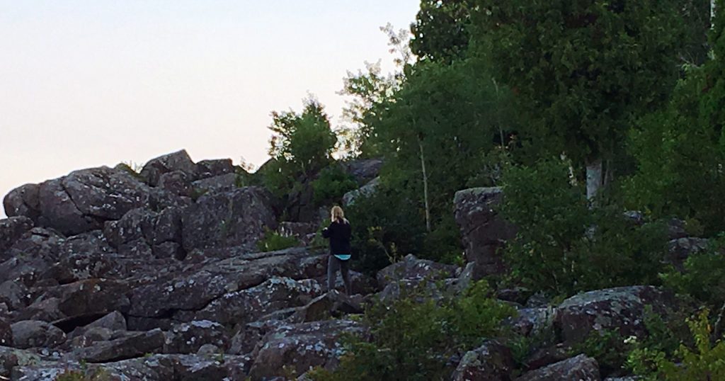 Peggy Gabrielson climbing the Tettegouche State Park rocks.